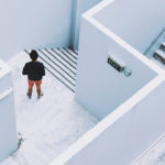 Overhead view of man standing in a maze-like building