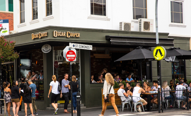 Busy corner cafe with people eating and shopping in Melbourne