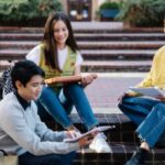 Photograph of a Group of Friends Sitting on Brick Steps