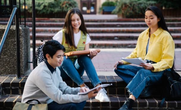 Photograph of a Group of Friends Sitting on Brick Steps