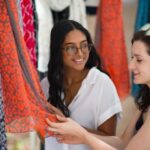 Two girls shopping for dresses