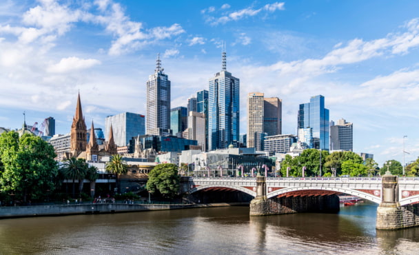 Perfect weather on high-rise towers in Melbourne CBD above Princes bridge across Yarra river.