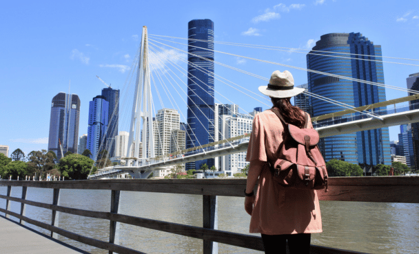 Rear view of adult woman looking at bridge across the Brisbane River in Brisbane, Australia.
