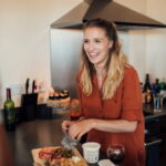 Group of friends in their 20s cooking at home in their flat.