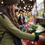 Young woman shopping for fresh produce at South Melbourne Market.