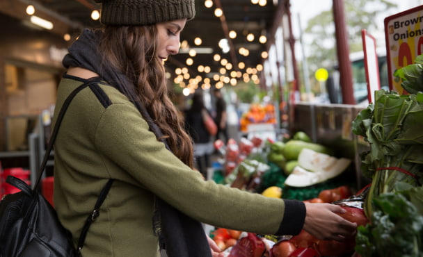 Young woman shopping for fresh produce at South Melbourne Market.