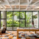 Students socialising and playing pool in summer-friendly communal space in Iglu Brisbane City student accommodation.