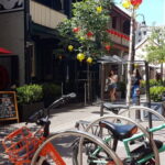 Outdoor laneway scene with bikes, cafes and pedestrians, representing student life near UTS and nearby accommodation.