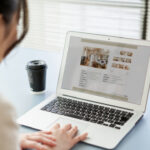Asian woman inspecting overseas student accommodation on her laptop