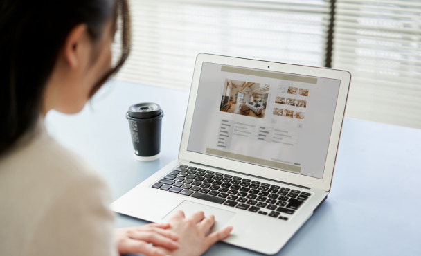 Asian woman inspecting overseas student accommodation on her laptop